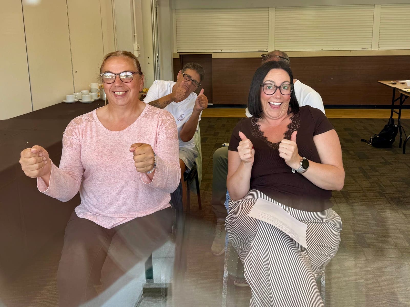 Two delegates giving a thumbs up during a workshop exercise