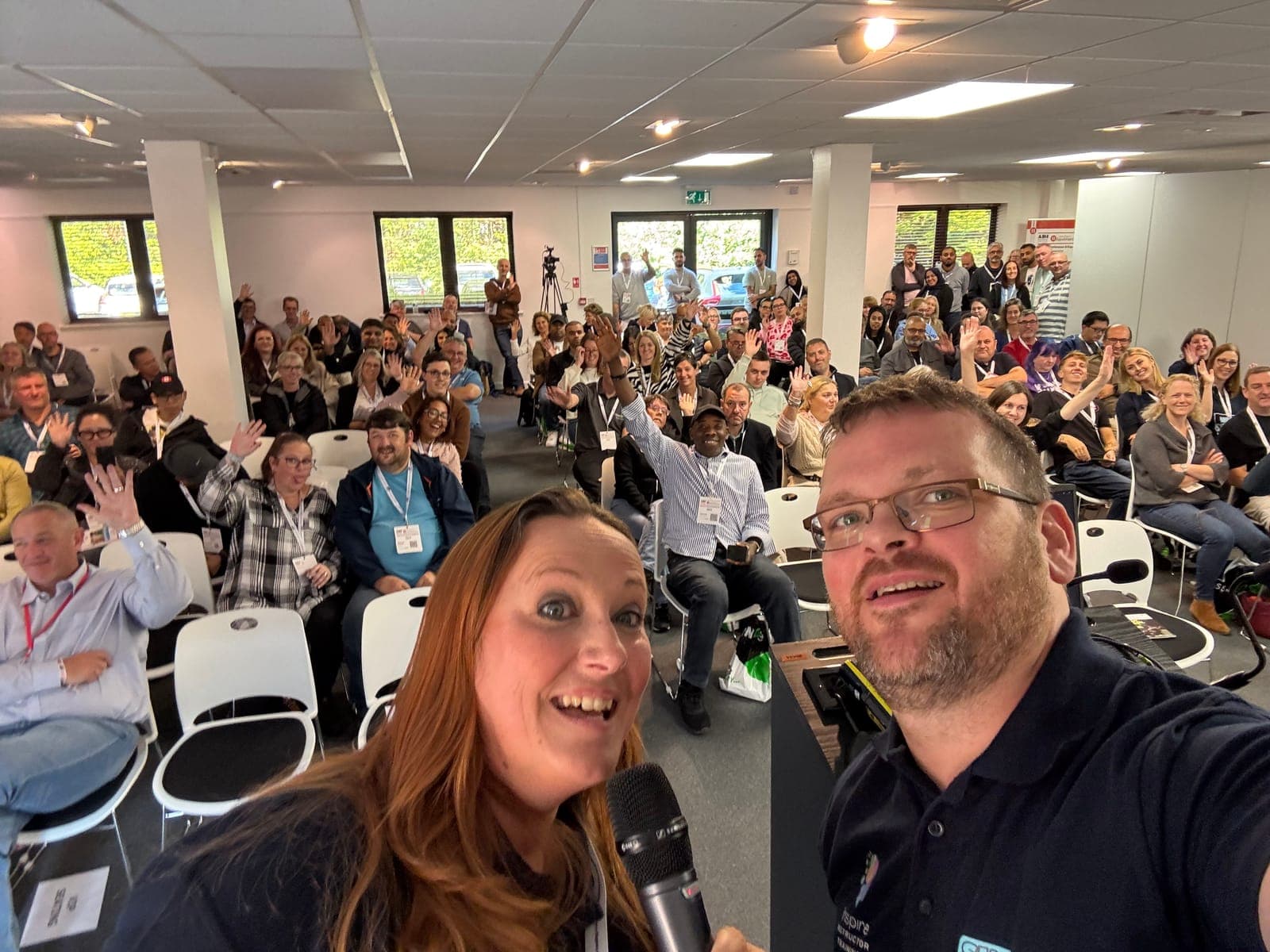 Phil and Diana speaking to a packed room of instructors
