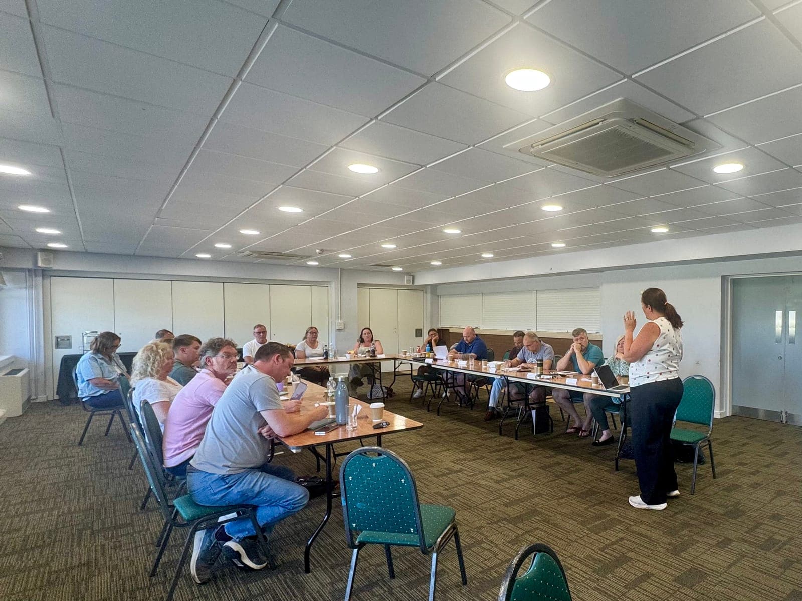 Diana leading a Train the Trainer workshop in a bright training room