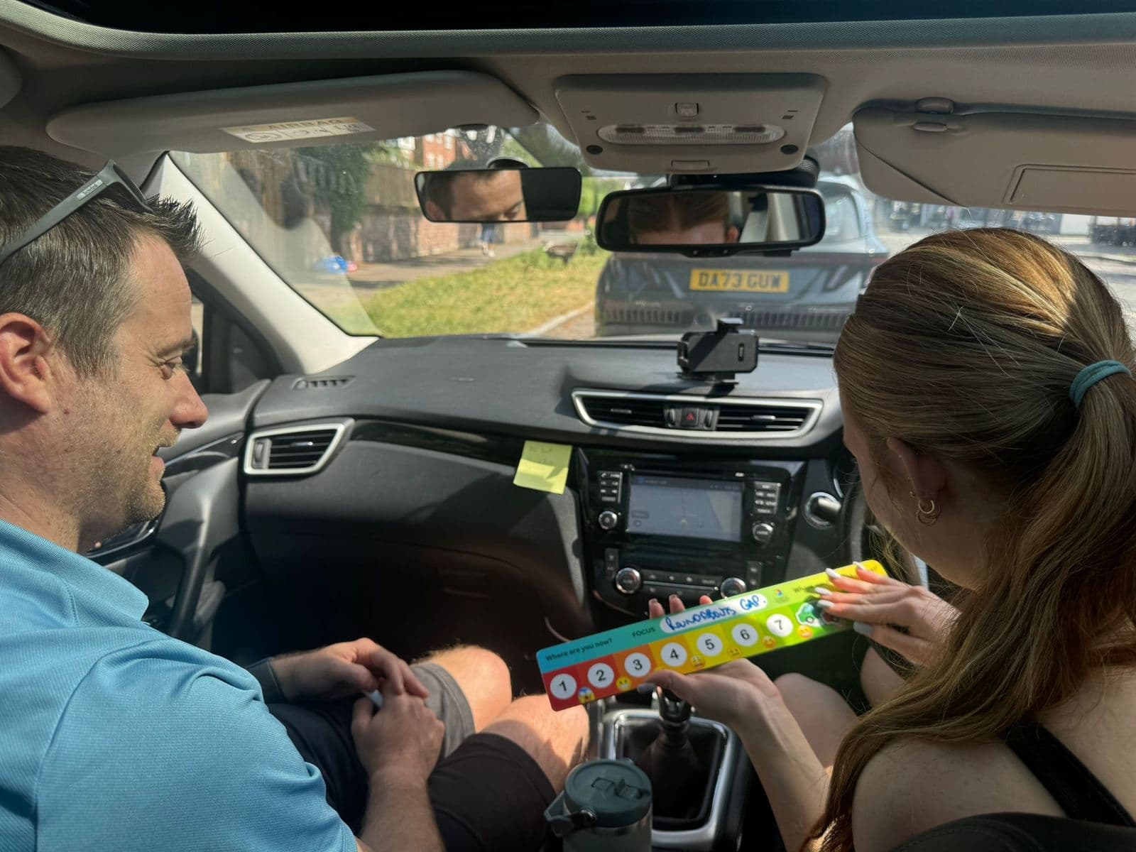 An instructor and pupil using the Scaling Board in the car